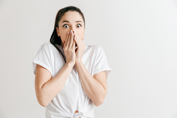 I'm afraid. Fright. Portrait of the scared woman. Business woman standing isolated on trendy gray studio background. Female half-length portrait. Human emotions, facial expression concept. Front view.