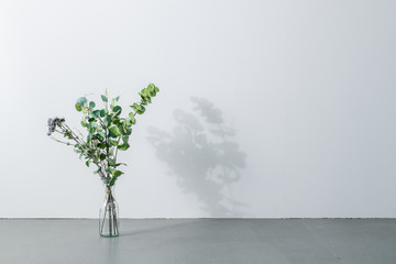 Bouquet in vase on white background. Modern lifestyle concept.