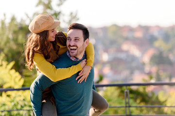 Beautiful young romantic couple in love having fun and feeling happy together outdoors in the sun