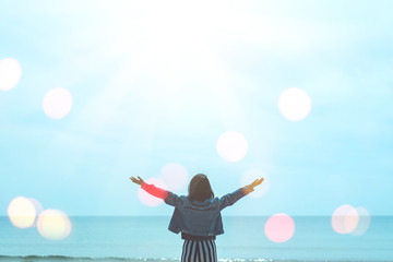 Copy space of woman rise hand up on blue sky at tropical beach and island background.