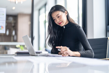Beautiful confident asian business woman working with laptop Hands typing keyboard. Professional investor working new start up project. business planning in office. Technology business